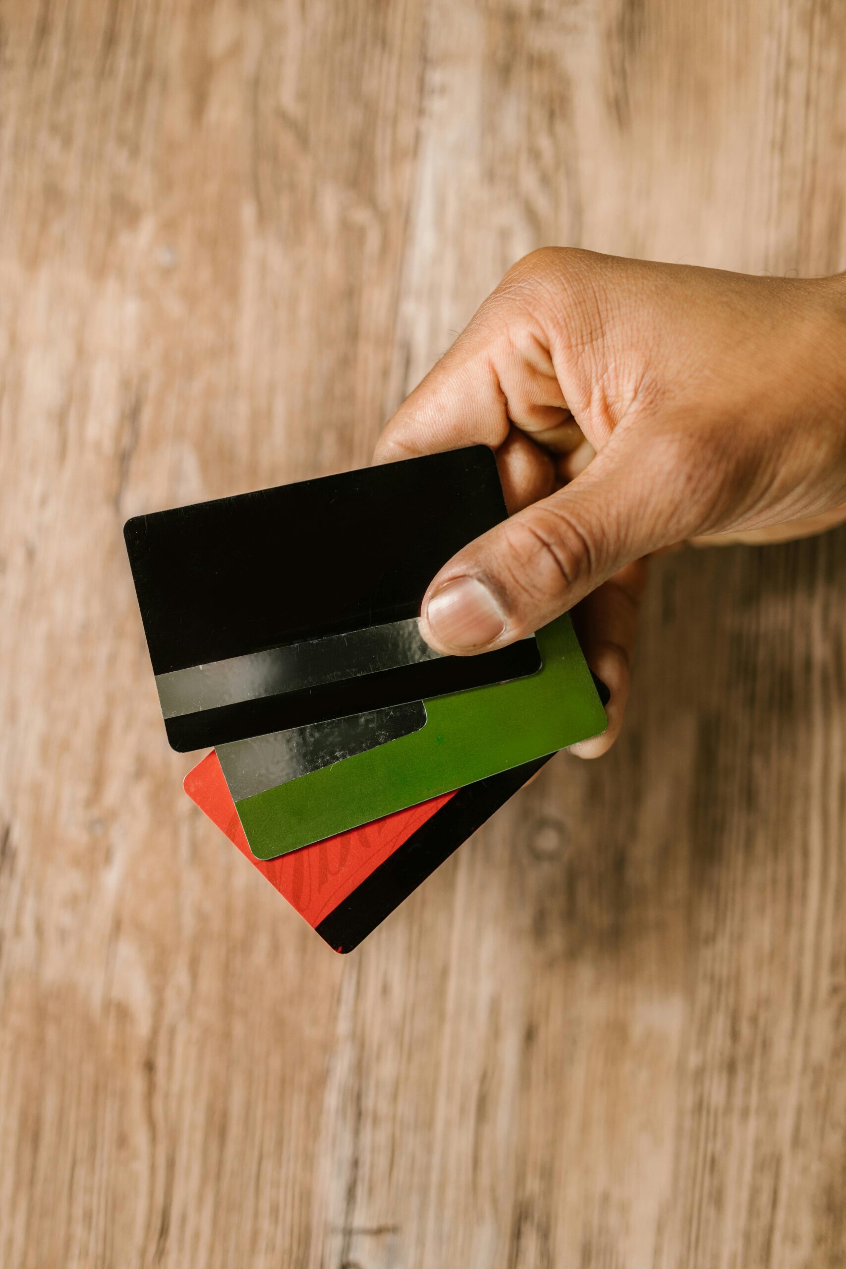 Man holding 3 credit cards