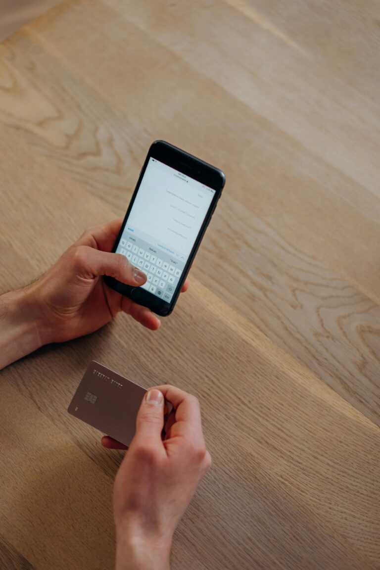 Man holding credit card and iphone